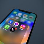 a close up of a cell phone with social media icons