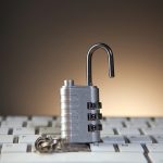 Open padlock with combination lock on keyboard